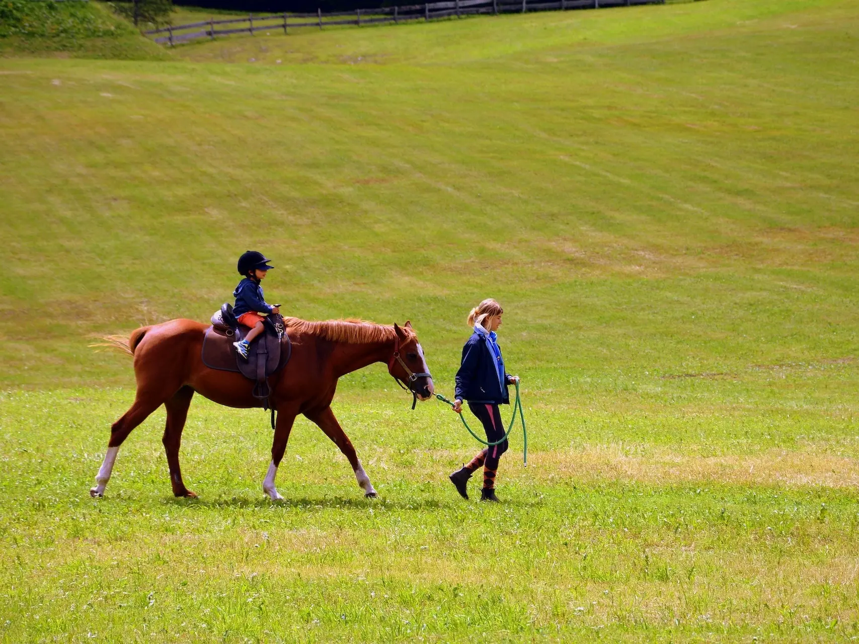 Woman leading a child on a horse