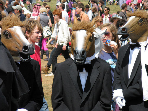 Men in horse costumes and tuxedos