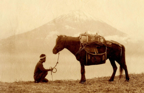 Man and pack horse in front of Mt. Fuji