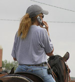 Mounted woman on a cell phone