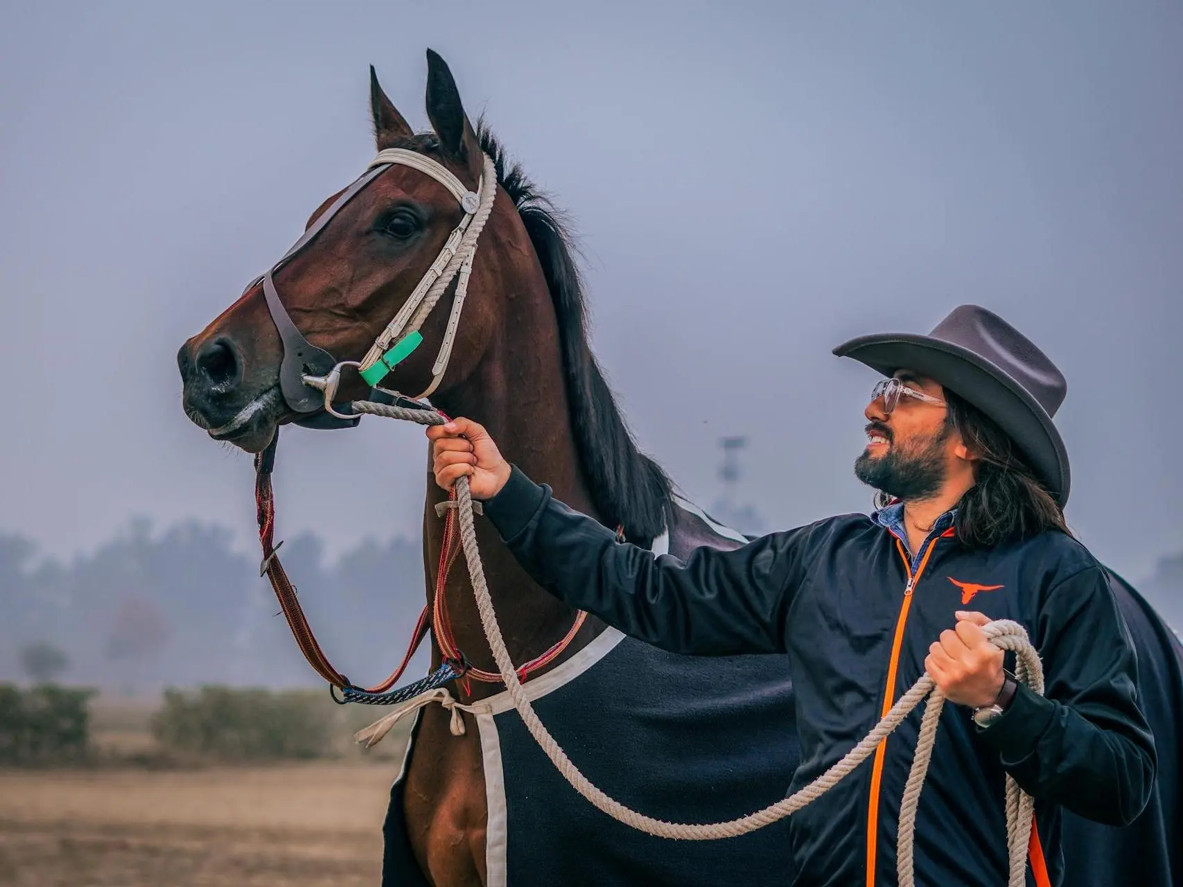 Man standing with a spirited racehorse