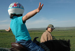 Riding instructor with a child on a horse
