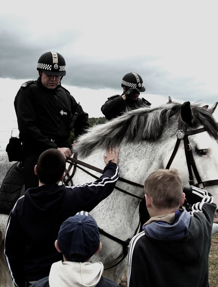 You're all under arrest! Mounted policemen stop to let kids pet their mounts